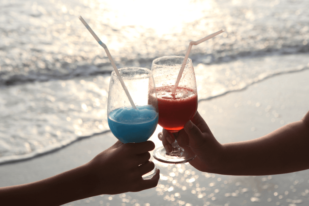 blue and red cocktail on a beach